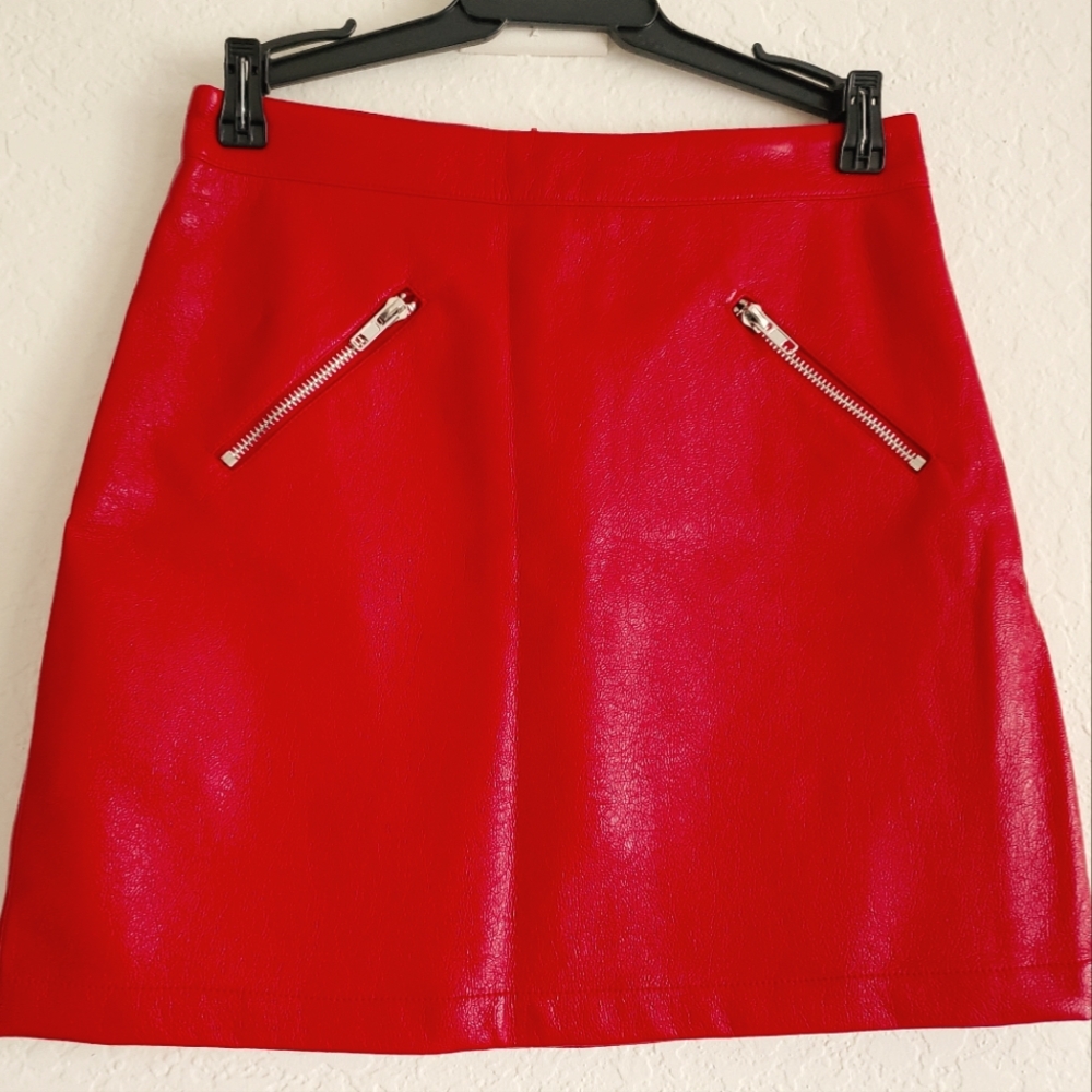 Pink Owl apparel Red faux leather skirt with 2 diagonal zippers on the front.